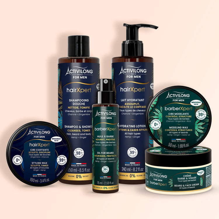 Six produits Activilong For Men sur fond rose poudré : trois pots, un flacon spray, deux flacons pompe noirs, gammes HairXpert bleue et BarberXpert verte.
