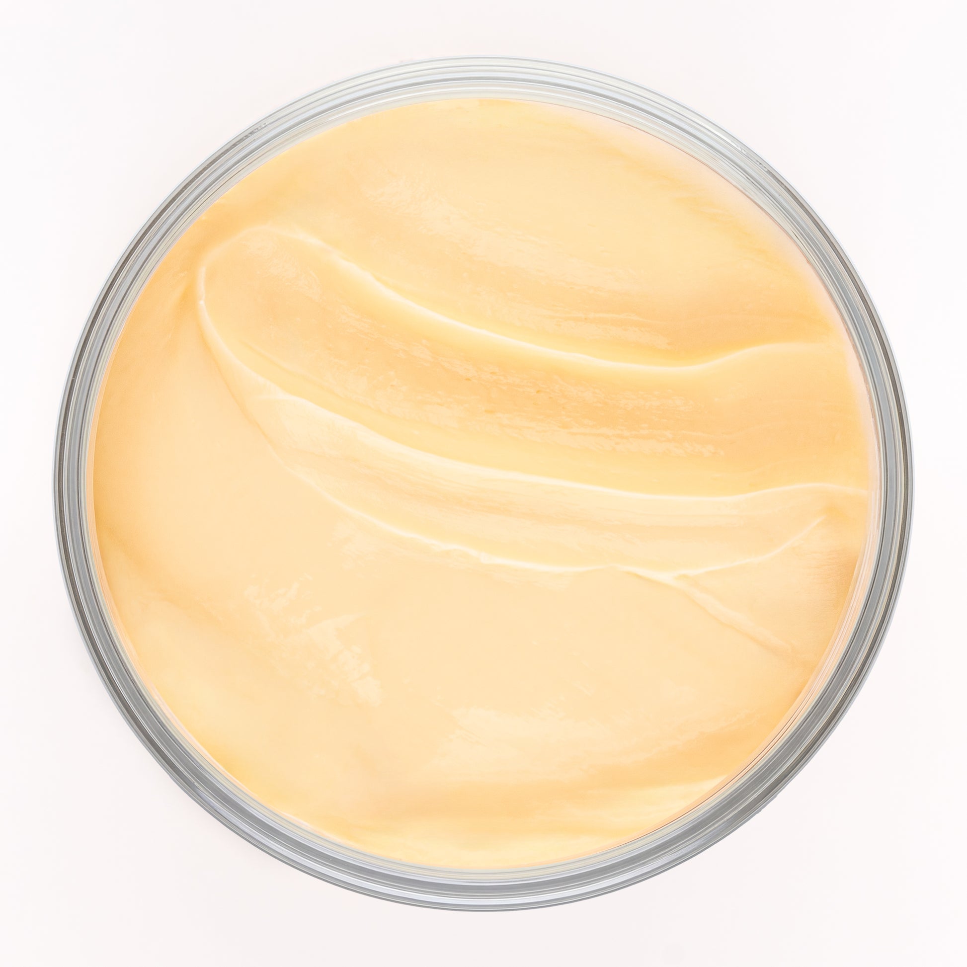 Visuel de la texture onctueuse de la Crème Soufflée Actiforce dans un pot vu de dessus sur fond clair